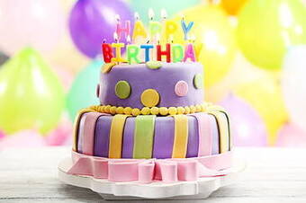 purple birthday cake with candles